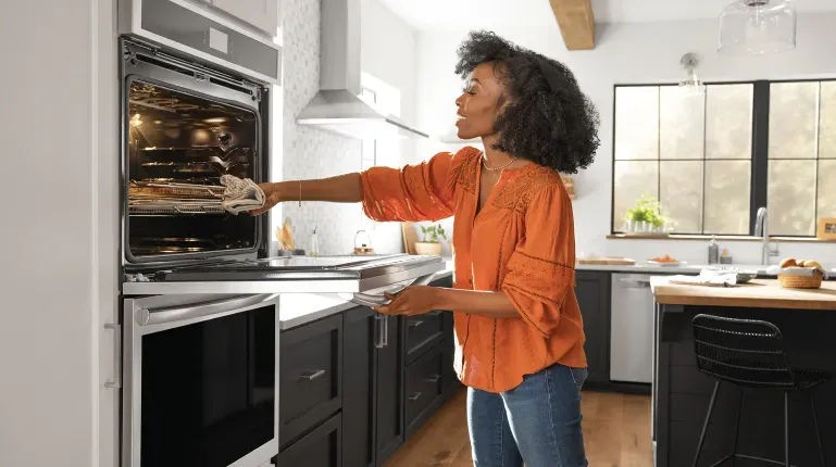frigidaire-gallery-wall-oven-woman-cooking